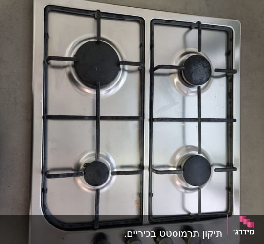 כיריים גז עם ארבעה מבערים וכפתורי שליטה